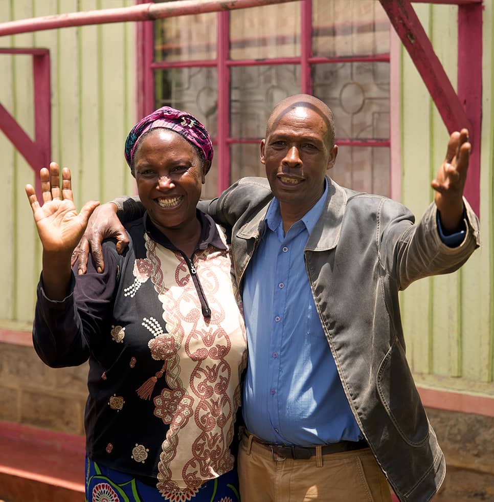 Local couple embracing and waving