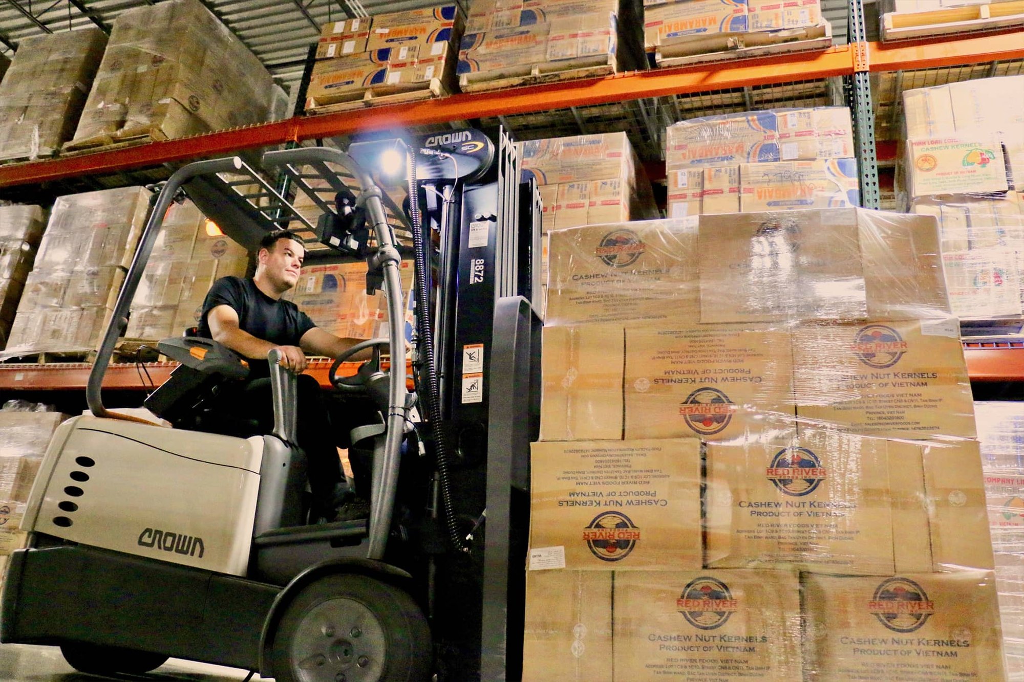 Red River worker using forklift and moving products